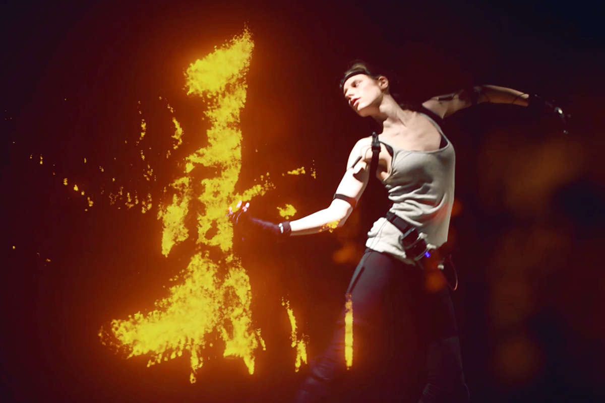 a dancer with expressive arms and flames in the background